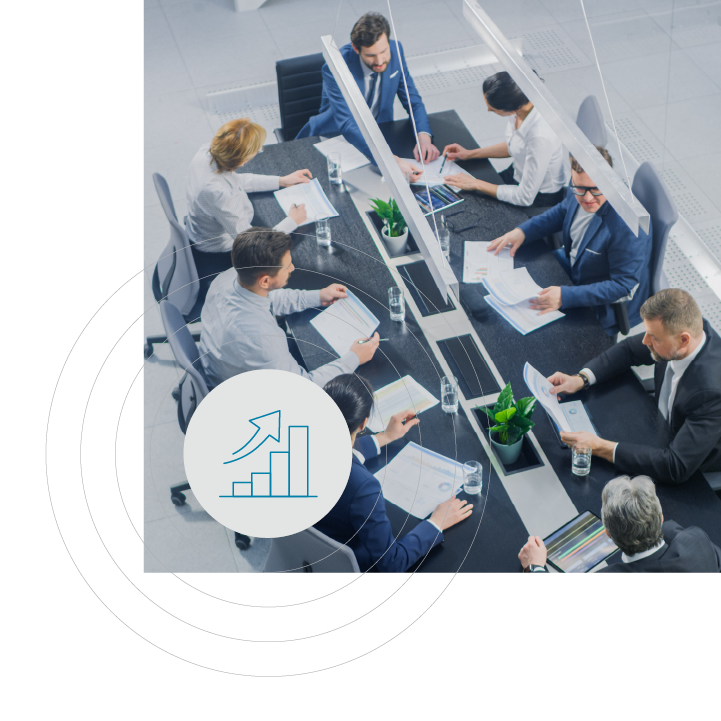 High-angle view of a business meeting with people in suits around a conference table, plastic dividers, and a growth icon overlay.