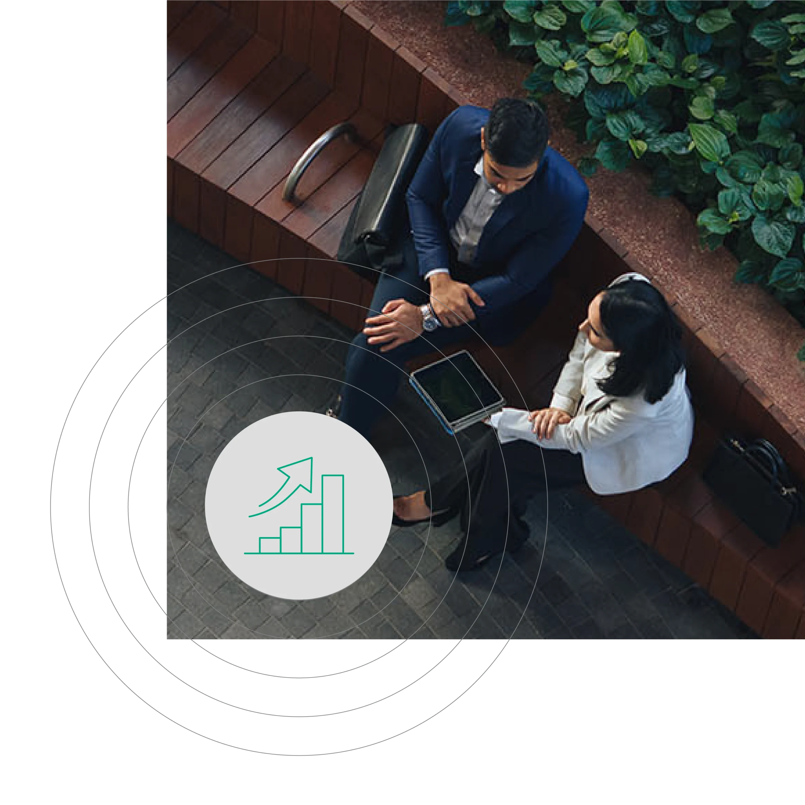 High-angle shot of two business professionals seated on a bench outdoors, conversing with a tablet. A growth icon overlays the scene, indicating professional progress.